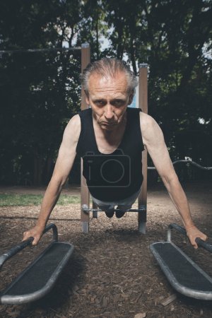 Photo for Ugly man of bad condition trying workout in outdoor gym - Royalty Free Image