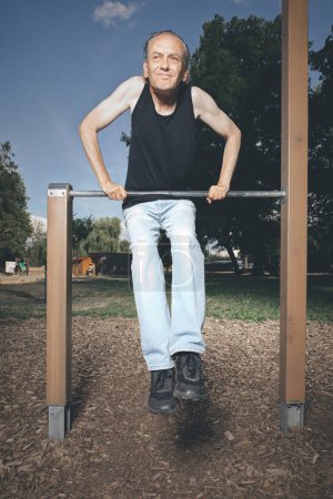 Photo for Ugly man of bad condition trying workout in outdoor gym - Royalty Free Image