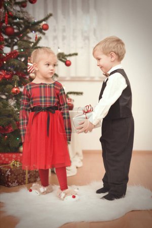 Foto de Los niños en el momento del día de Navidad desempaquetar regalos cerca del árbol - Imagen libre de derechos