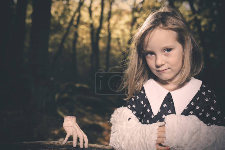Photo for Young girl in halloween style posing in autumn forest - Royalty Free Image