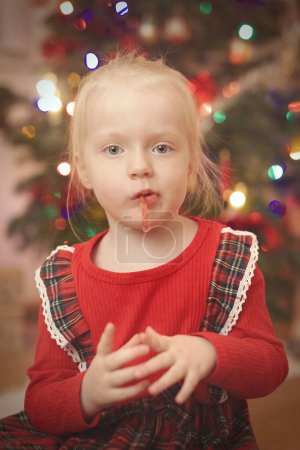 Photo for Children at time of christmas day unpacking gifts near tree - Royalty Free Image