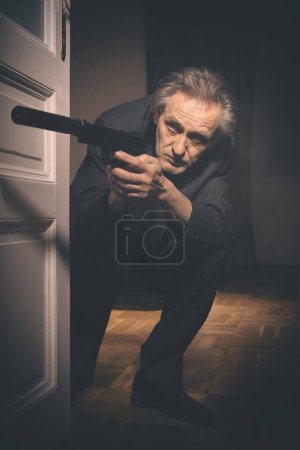 Photo for Old member of criminal  gang shooting victim in hotel room - Royalty Free Image