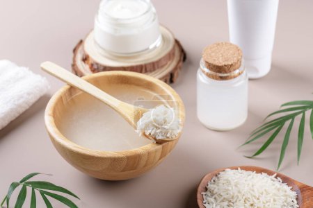 Photo for Homemade cosmetic rice water with ingredients and beauty kit on beige background, healthy beauty treatment ingredients for homemade comsetics, beauty recipe for home spa, natural skincare preparation - Royalty Free Image