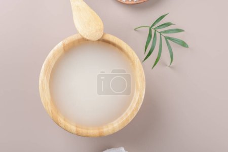 Photo for Homemade cosmetic rice water with ingredients on beige background, healthy beauty treatment ingredients for homemade comsetics, beauty recipe for home spa, natural skincare preparation, close up - Royalty Free Image