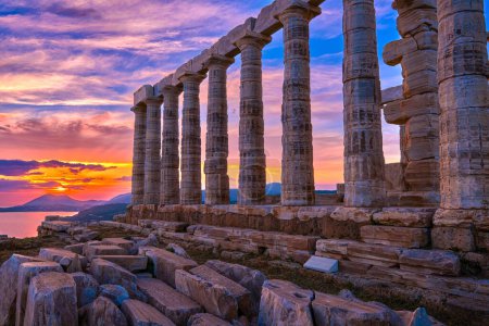 Photo for Beautiful sunset sky and ancient ruins of temple of Poseidon, cape Sounio, Aegean sea coast, Greece. Travel destination of Athens area, important center of ancient Greek religion for Olympian Greek - Royalty Free Image