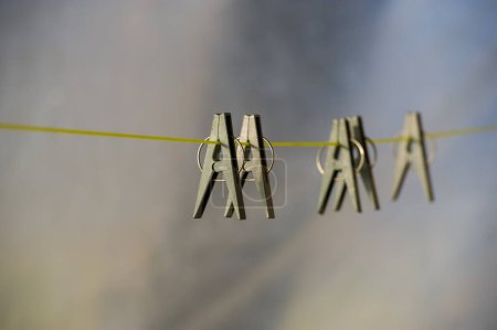 Téléchargez les photos : Pinces à linge Liinen grises sur une corde sur un fond flou. Bannière Web. - en image libre de droit