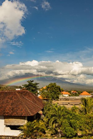 Beautiful rainbow over Agung volcano on sunny day Amed beach Bali Indonesia