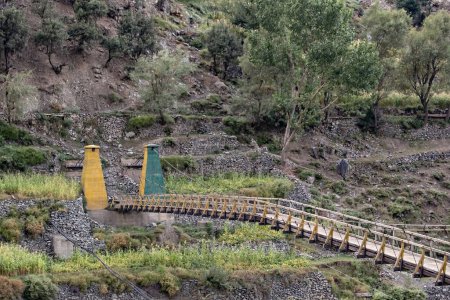 Photo for Old wooden suspension bridge in Chitral Valley, Karakoram Highway, Pakistan - Royalty Free Image
