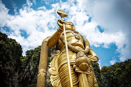 Photo for People visiting Batu Caves in Kuala Lumpur city. Giant Murugan statue at the entrance of Batu Caves, Malaysia - Royalty Free Image