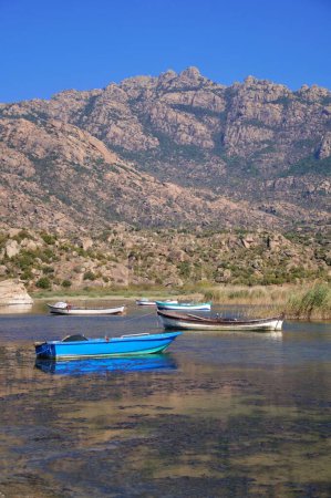Téléchargez les photos : Fishing boats moored along the shore of Lake Bafa in Turkey. - en image libre de droit