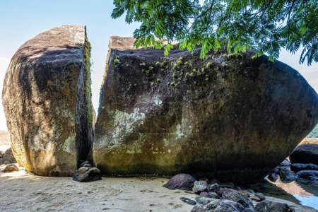 Photo for Splitted stone at Abraao Preta beach on big island Ilha Grande in Angra dos Reis, Rio de Janeiro, Brazil, South America - Royalty Free Image