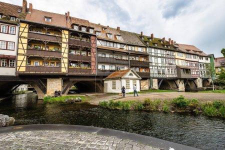 Photo for Erfurt, Germany - May 13, 2023: Merchants Bridge, Kraemerbruecke in Erfurt, Germany. It was built in 1325. The only bridge north of the Alps that is built over entirely with houses - Royalty Free Image