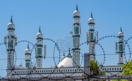 Photo for Athlon Cape Town, South Africa, February 10, 2023: Blurred barbed wire in foreground at Habibia Soofie Masjid Mosque in Athlone near Cape Town South Africa - Royalty Free Image