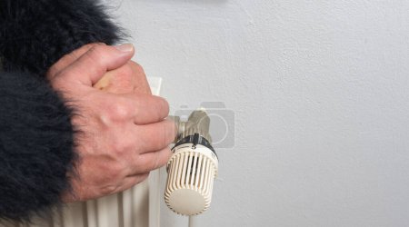 Photo for Warm up hands and body on a heater - Royalty Free Image