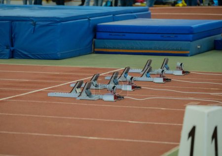 Photo for Starting blocks and athletics track in an athletics sports hall - Royalty Free Image
