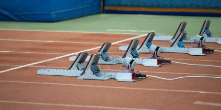 Photo for Starting blocks and athletics track in an athletics sports hall - Royalty Free Image