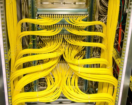 Yellow RJ45 copper cable - Network Cable in a network distribution rack in the data center
