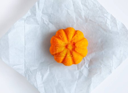 Photo for Scented orange bath bomb in the shape of a pumpkin. Skin care product. - Royalty Free Image