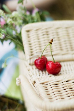 Photo for Wicker basket and red cherry. Summer picnic concept, - Royalty Free Image
