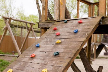 Photo for Climbing wall at wooden playground outdoors in the park - Royalty Free Image