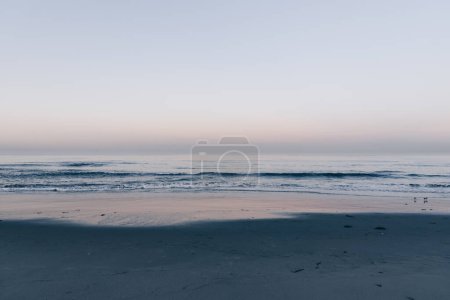 Photo for Calm sunrise on the beach with pink sky on the background - Royalty Free Image