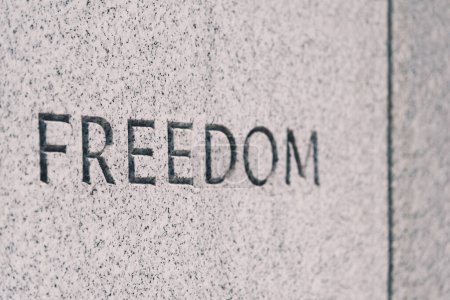 The word Freedom written in the concrete