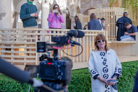 Photo for MILAN, ITALY - 17 APRIL 2023: interview with Gilda Bojardi, director of Interni magazine, during the Fuorisalone in the garden of the state university during design week - Royalty Free Image