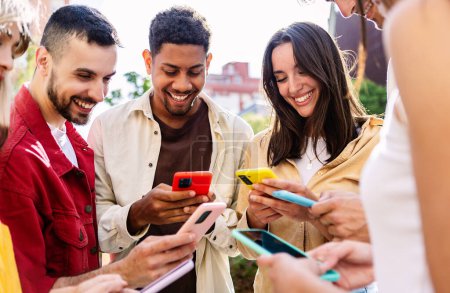 Photo for Happy group of young student friends holding mobile phones at city street. Diverse millennial people using cell phones addicted to social media app. Technology and youth concept. - Royalty Free Image