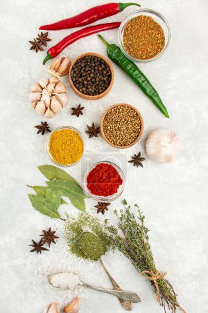 Photo for A variety of spices and herbs on a light table. Cooking background. View from above. Ingredients for cooking. Table background menu. - Royalty Free Image