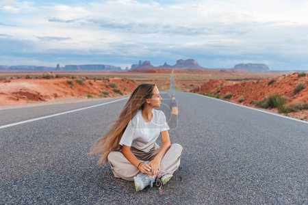 Scenic highway in Monument Valley Tribal Park in Utah. Happy girl on famous road in Monument Valley in Utah. 