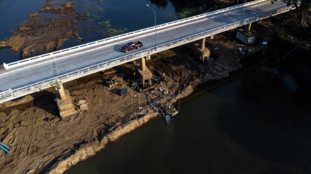 Photo for Aerial view of renovation and repair work on the river bridge road. - Royalty Free Image