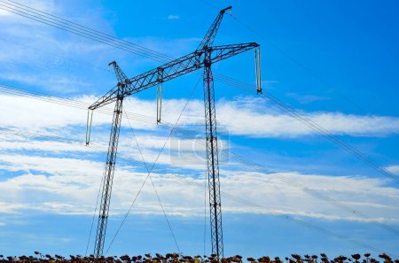 Photo for Supports of high voltage lines against the blue sky - Royalty Free Image