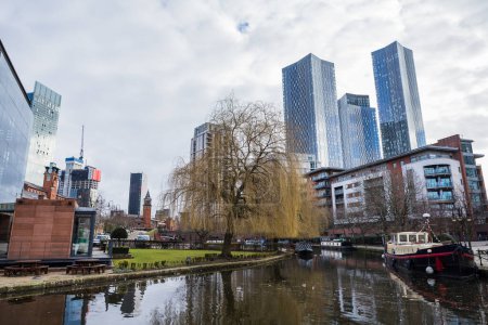 Photo for Castlefield Basin off the Rochdale Canal pictured in February 2023 agaisnt the Beetham Tower and the Deansgate Square skyscraper complex. - Royalty Free Image