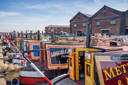 Photo for Colourful narrow boats lined up in Ellesmere Port basin seen during the Easter Boat Gathering in April 2023. - Royalty Free Image