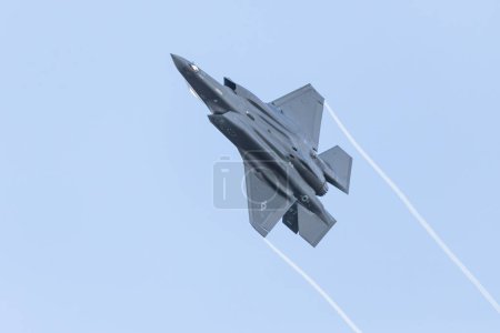 Photo for An F-35A Lightning II seen trailing vapour from its wing tips departs RAF Lakenheath at speed as it embarks on a training sortie over the United Kingdom. - Royalty Free Image