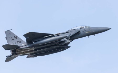 Photo for F-15E Strike Eagle climbs to the sky after taking off from its base at RAF Lakenheath in Suffolk to complete a training sortie in August 2023. - Royalty Free Image