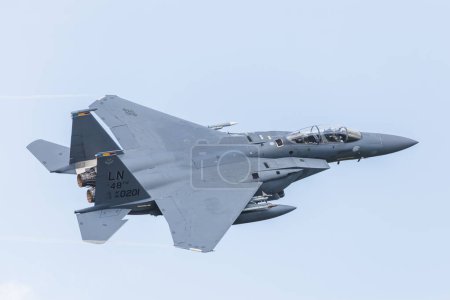 Photo for An F-15E Strike Eagle showing the markings representing the three squadrons that made up the 48th Fighter Wing prior to the delivery of the F-35As, (the 492nd Bolars/Madhatters, the 493rd Grim Reapers, and the 494th Panthers) takes off from RAF Laken - Royalty Free Image