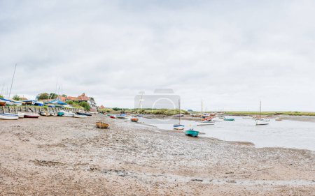 Photo for A multi image panorama of boats seen at low tide at Burnham Overy Staithe  on the North Norfolk coast seen in August 2023. - Royalty Free Image