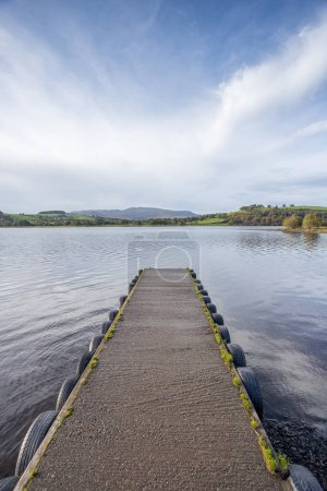 Photo for Overlooking a landing stage which juts into the water of Lake Bala in Snowdonia National Park. - Royalty Free Image