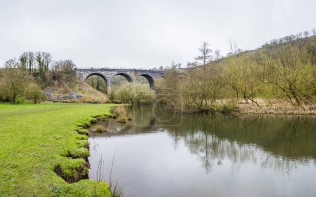 A multi image panorama of the Monsal Head Bridge pictured from the edge of the River Wye looking up at the Monsal Trail.