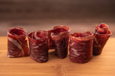 Photo for Dry-cured Spanish ham, Serrano ham, Bellota ham, Italian prosciutto crudo or Parma ham, wagyu slice. High quality photo - Royalty Free Image