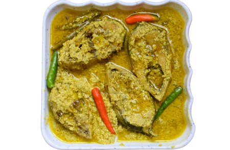 Photo for Sorshe Illish or Hilsa fish cooking with mustard seed, green chili, and poppy seeds over white background. Famous Bengali food. Selective focus. - Royalty Free Image