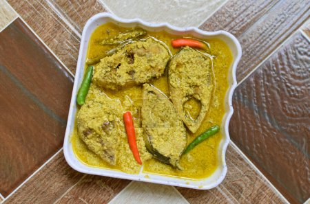 Photo for Sorshe Illish or Hilsa fish cooking with mustard seed. Famous Bengali food. Selective focus. - Royalty Free Image