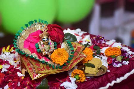 Photo for Bal Krishna Laddu Gopal, an Hindu God, brass statue with beautiful pink cloths and jewelry. Celebrating Krishna Janmashtami concept. Selective focus. - Royalty Free Image