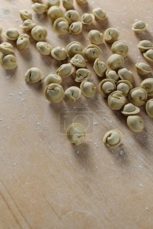 Photo for Handmade sculpting dumplings laid out on a wooden dough board. - Royalty Free Image