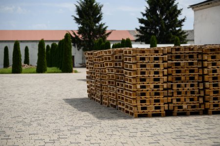 Photo for A pile of fresh wooden pallets near the storage facility. - Royalty Free Image