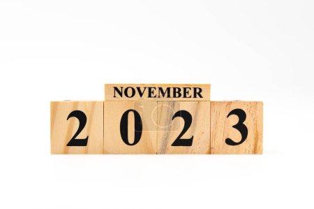 Photo for November 2023 written on wooden blocks isolated on white background with copy space. - Royalty Free Image