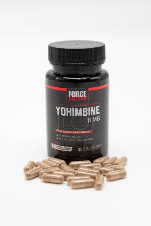 Photo for Fuji, Shizuoka, Japan - April 26, 2023: Yohimbine Force Factor 6 mg with scattered capsules isolated on white background. - Royalty Free Image