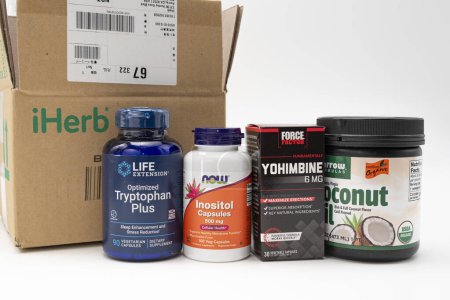 Photo for Fuji, Shizuoka, Japan - March 21, 2023: Cardboard box from iHerb online store with supplements: Tryptophan Plus, Inositol 500 mg, Yohimbine 6 mg and Coconut Oil. Isolated on White Background. - Royalty Free Image