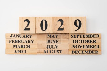 Photo for Year 2029 written on wooden cubes on top of the months of the year written on twelve rectangular pieces of wood. Isolated on white background. - Royalty Free Image